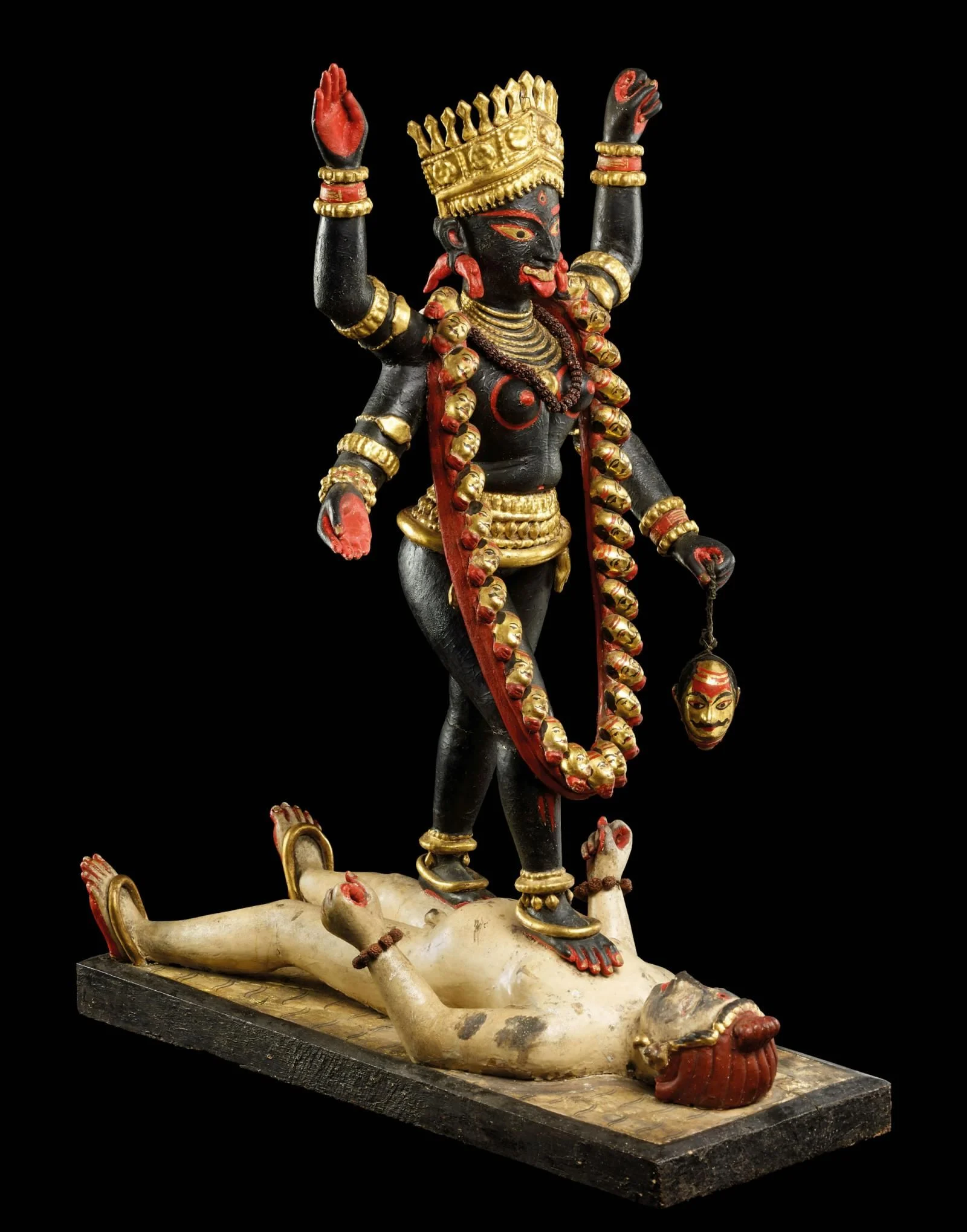 Painted and gilded clay figure of Kali striding over Shiva, Bengal, Eastern India, late 19th century
